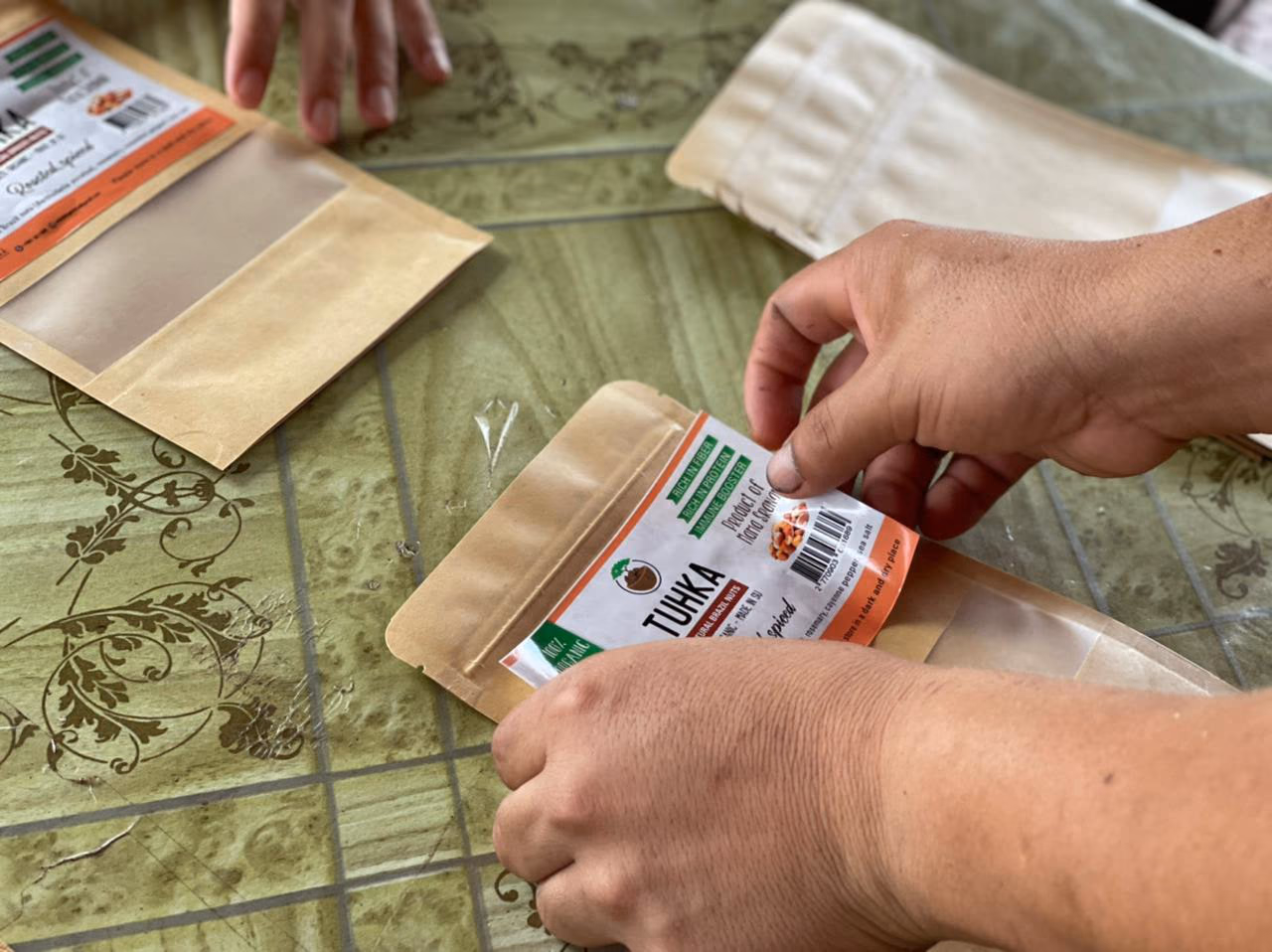 Applying labels to Tuhka packaging by hand